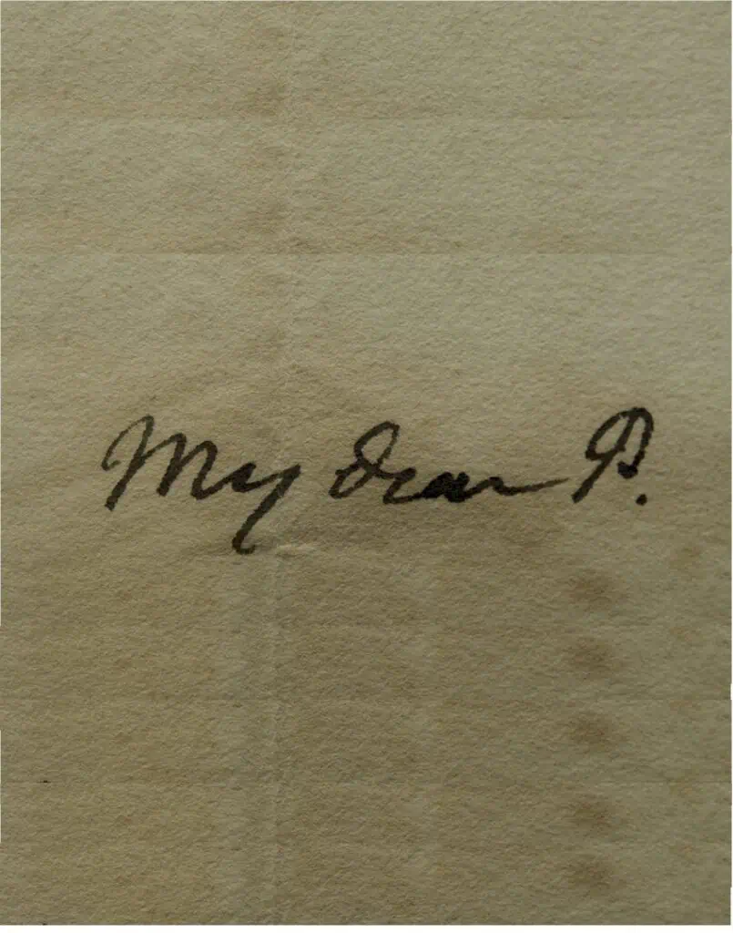 Close-up of a handwritten note on textured paper that begins with "My Dear D." in dark ink.