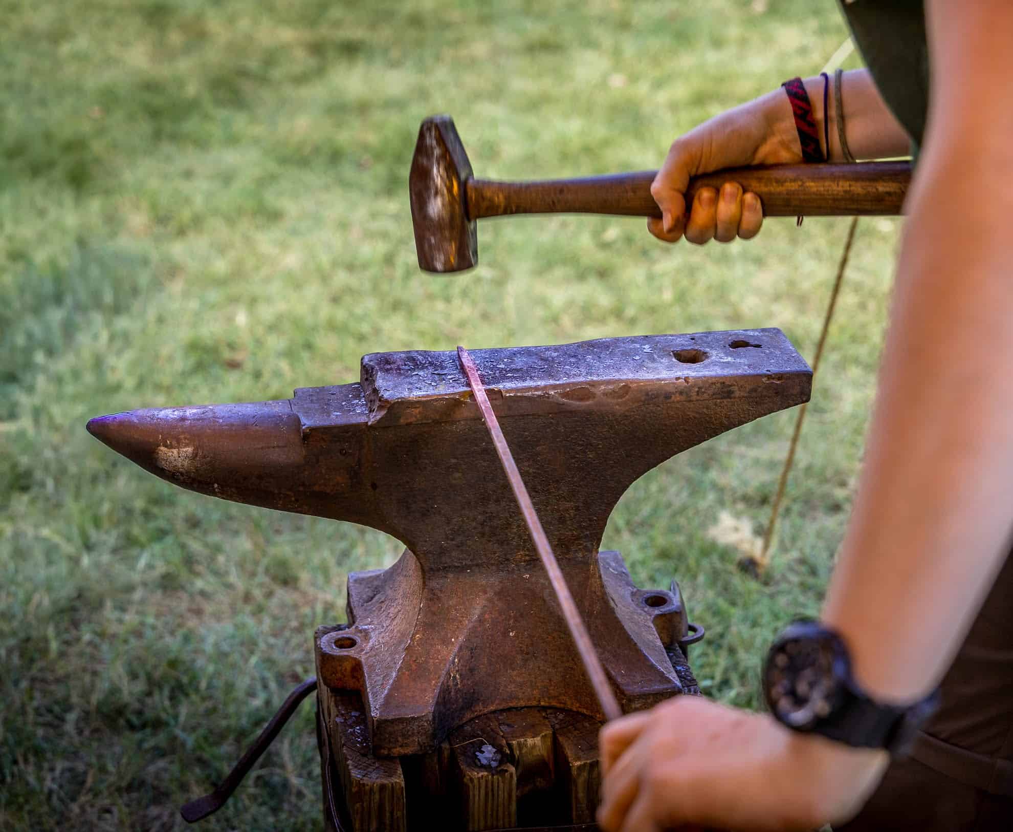 Participant hammering nail stock to a point for the creation of a wrought nail. Participants will learn a range of metal working under the direction of heritage blacksmiths.Photograph by Gene Runion