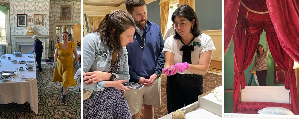 A group of people tours a historic house museum, examining set tables, artifacts, and an ornate bed on display.