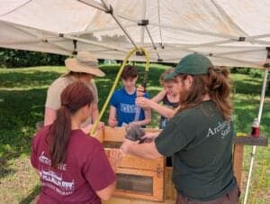 High school students learning waterscreening of soils at lab.